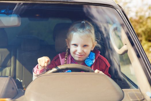 small girl driving a car