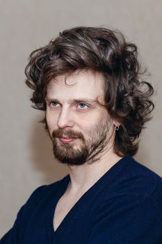 Dramatic portrait of the poet with curly hair when thinking shot closeup