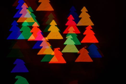 Defocused christmas background in multi-colored fir shot closeup