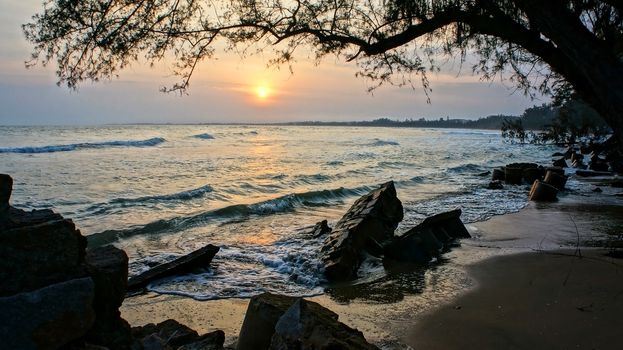 Erosion at seaside, wave destroy seawall, effect of climate change, this is global environment problem in future, destroyed breakwater  in silhouette under the sun at sunset