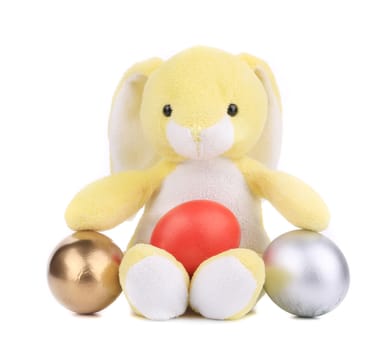 Yellow toy rabbit with easter eggs. Isolated on a white background.
