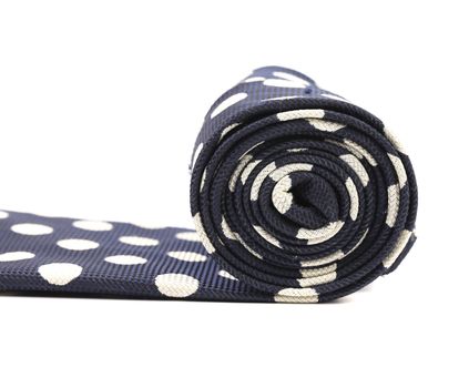 Folded blue tie with white speck. Isolated on a white background.