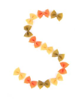 Letter S written with colored farfalle on white background