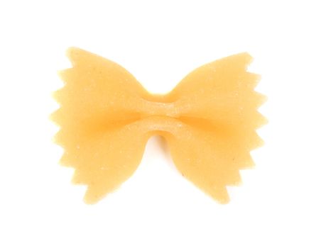 One yellow farfalle. Isolated on a white background.