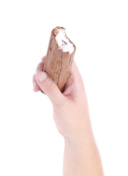 hand holds a roll of chocolate ice cream. Isolated on a white background