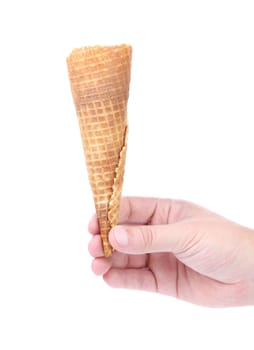 Hand holds empty ice cream corn. isolated on a white background