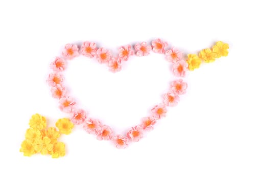 Heart made ??of artificial flowers. On a white background.