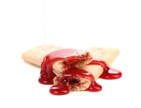 Red syrup stream on stics of biscuit. Isolated on a white background