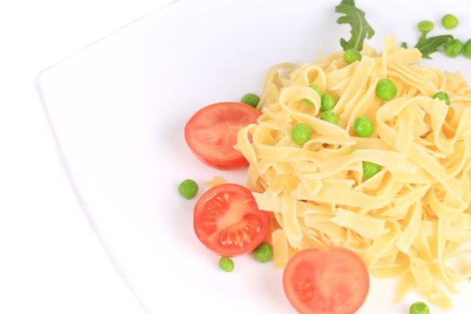 Pasta with green peas on plate close up. Whole background.
