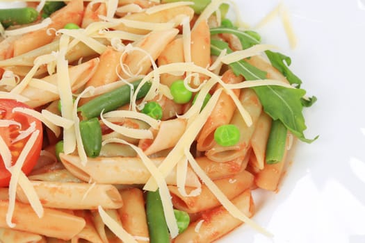 Pasta with tomato sauce and vegetables. Whole background.