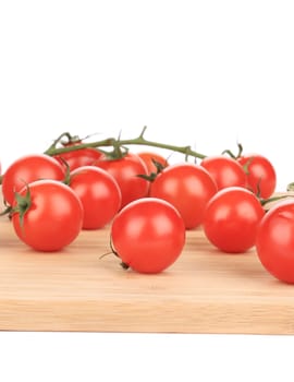 close up of Cluster of Tomatoes on wooden platter. Isolated on a white background.
