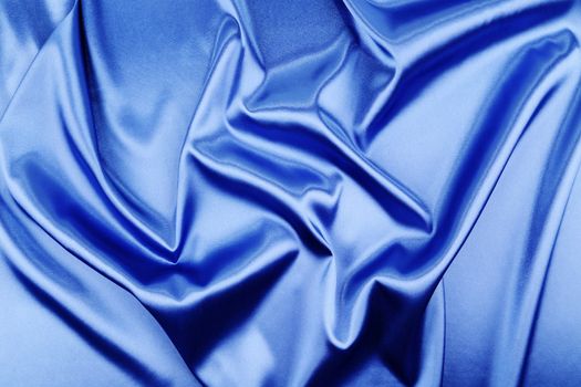 Blue silk background with some soft folds and highlights