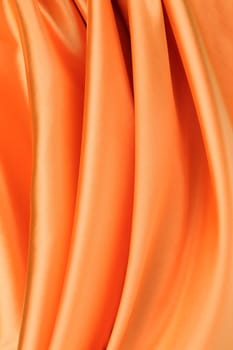 Folded orange silk. To be used as background.