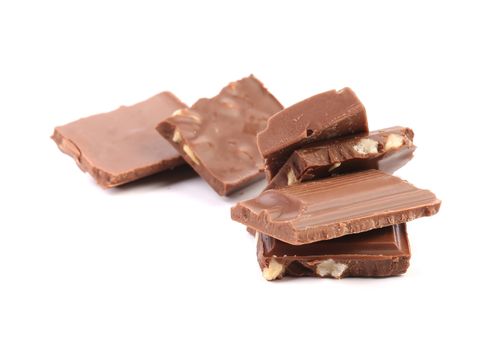 Tasty morsel of milk chocolate with nuts. Isolated on a white background.