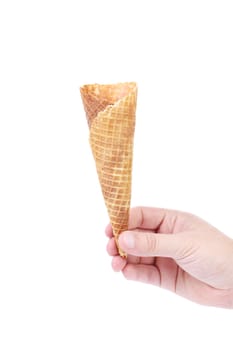 Hand holds empty ice cream corn. isolated on a white background