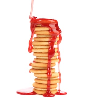 Stack of cookie biscuits with filling in strawberry sauce. Isolated on a white background