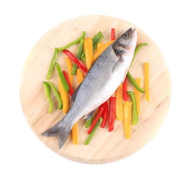 Fresh seabass fish on colorful pepper. Isolated on a white background.