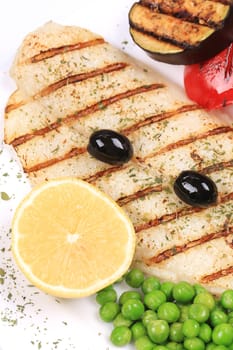Pangasius fillet grilled with vegetables. Whole background.