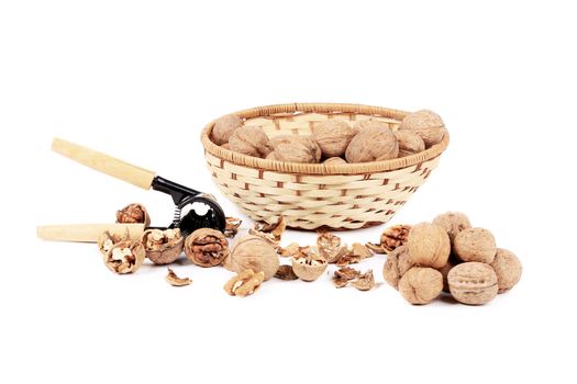 Walnuts in basket and nutcracker. Isolated on a white background.