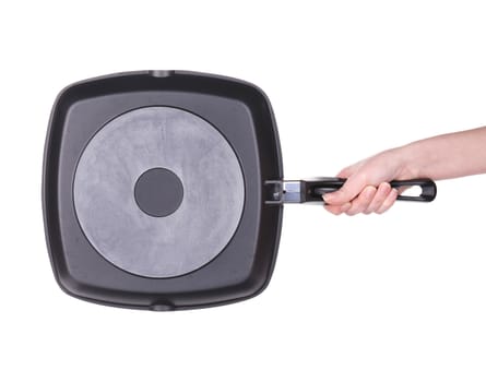 Hand holds a black frying pan. Isolated on white background