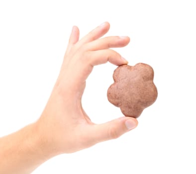 Hand holds chocolate meringues. Isolated on a white background
