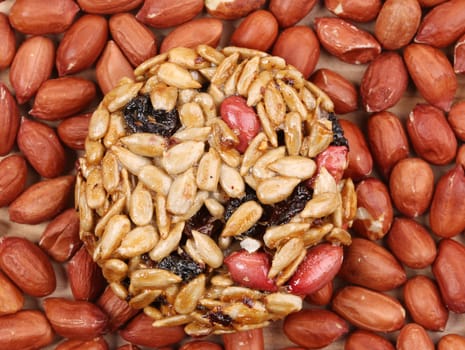 Sunflower seeds and raisins in caramel. Located on the whole background.