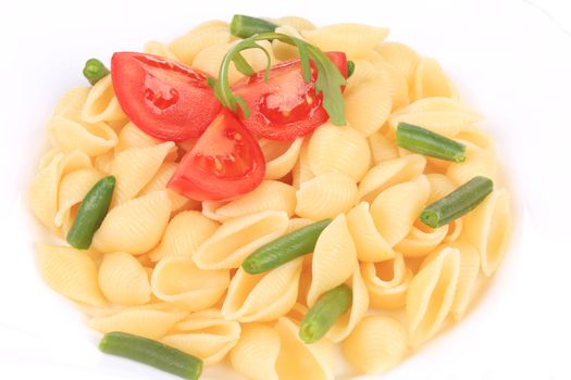 pasta shells with vegetables on white plate. isolated on a white background