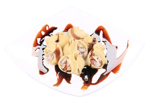 pasta shells stuffed with mushrooms on a white plate.