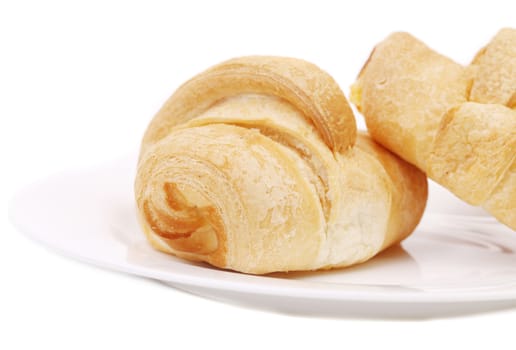 fresh croissants on white plate. isolated on a white background