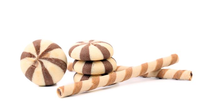 Striped chocolate wafer rolls and stake biscuits. Isolated on a white background