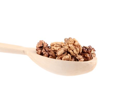 Wooden spoon full with walnuts. Isolated on a white background.