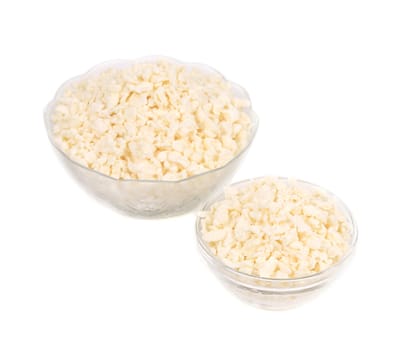 White cottage cheese in a bowls. Isolated on a white background.