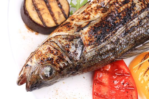 Grilled fish with eggplant. Isolated on a white background.