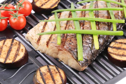 Grilled fish and vegetables. Isolated on a white background.