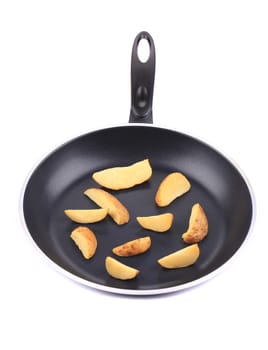 fried potato in the pan. Isolated on a white background.