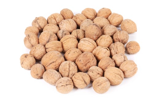 Pile of walnuts. Isolated on a white background.