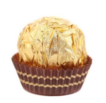 close up of chocolate gold bonbon. isolated on a white background