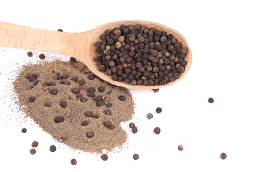 black peppercorns and milled in wooden spoon.Isolated on a white background
