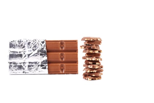 Dark chocolate bar in foil. Isolated on a white background.
