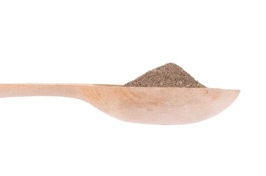 Heap of powdered black pepper on a spoon. Isolated on a white background.