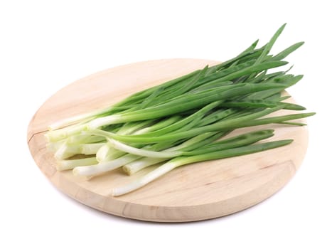 Green onions on the board. Isolated on a white background.