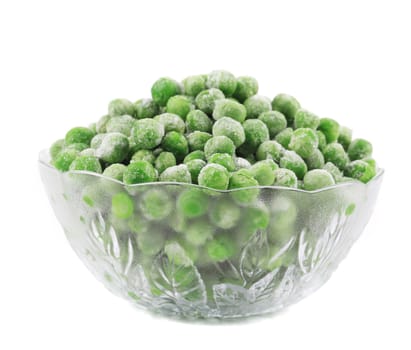 Frozen green peas in glass bowl. Isolated on a white background.