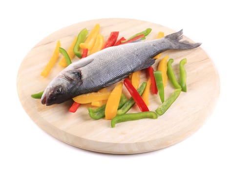 Raw seabass with pepper slices. Isolated on a white background.