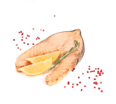 Fried salmon steak with rosemary and lemon. Isolated on a white background.