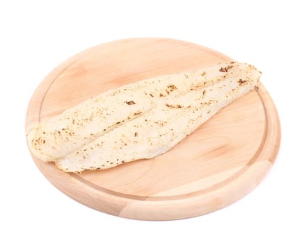 Grilled pangasius fillet on platter. Isolated on a white background.