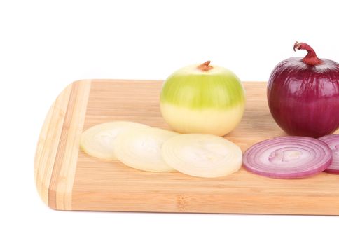 close up of  red and white onions on wooden platter. isolated on a white background