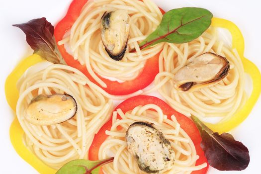 Pasta with mussels and basil. Isolated on a white background.