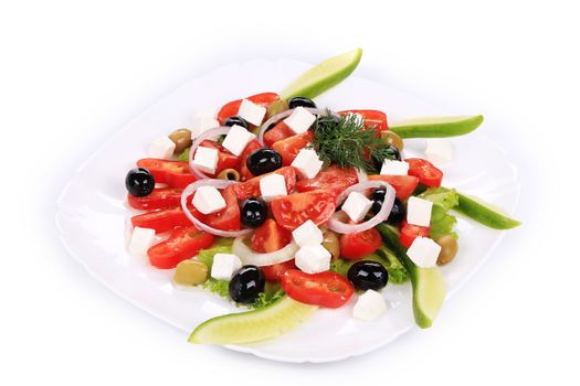 Greek salad in plate. Isolated on a white background.