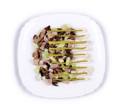 Delicious salad with beef tongue. Isolated on a white background.