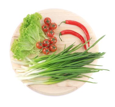 Vegetables and herbs on platter. Isolated on a white background.